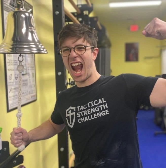 Coach flexing at Iron Monkey Strength